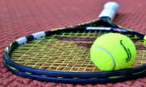 green-tennis-ball-on-tennis-court